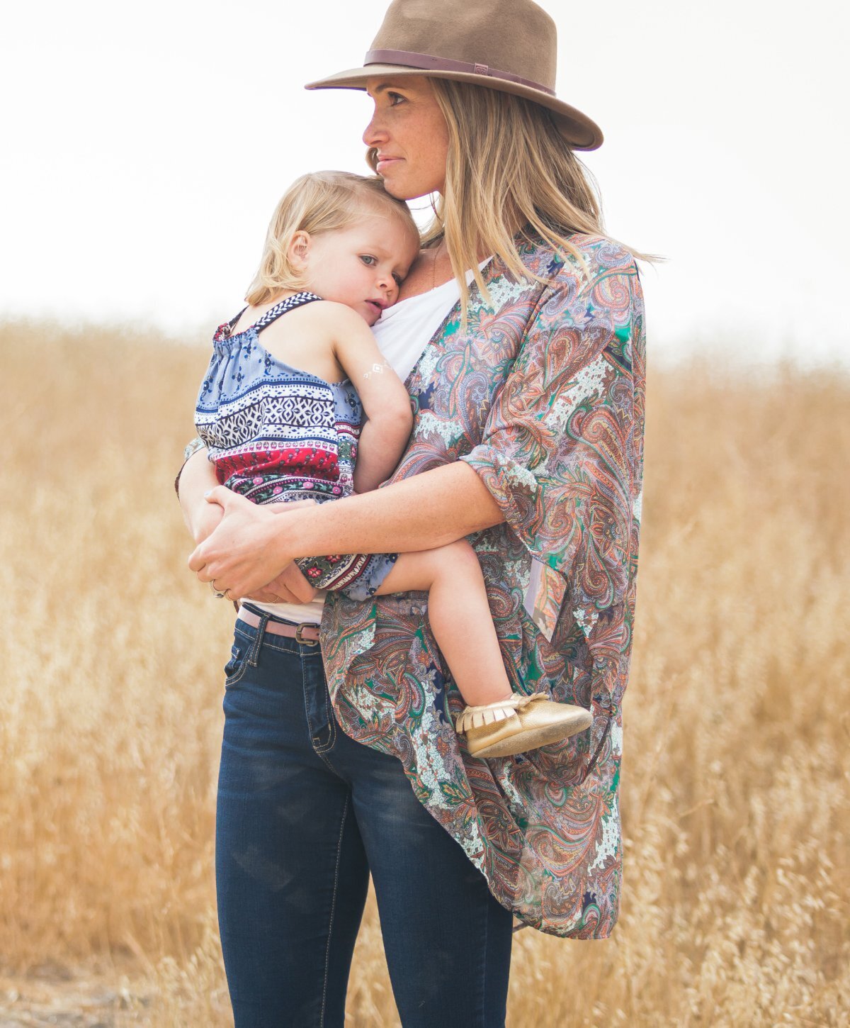 Mommy Makeover client holding a child