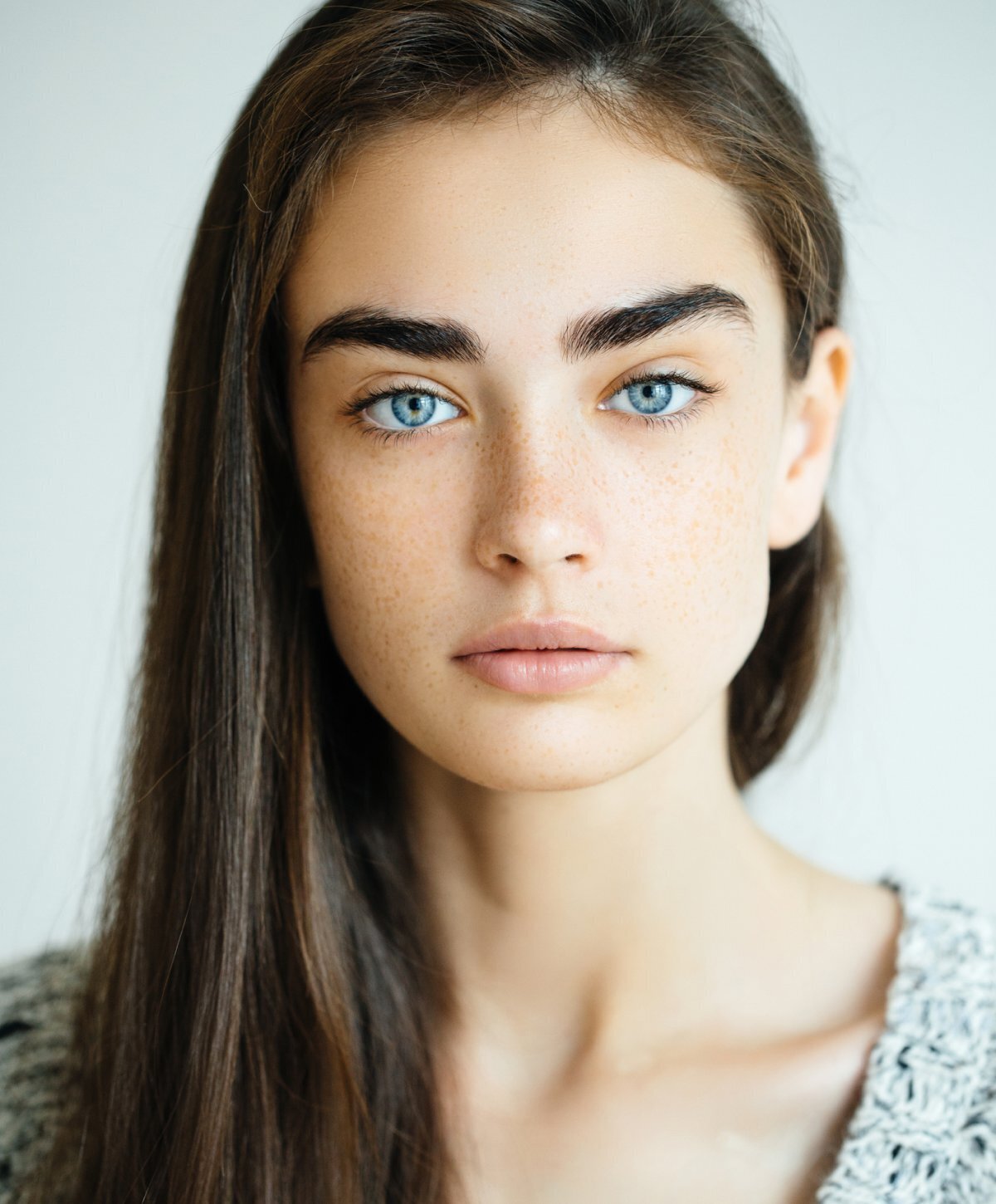 dysport patient model in a grey sweater with her hair over her shoulder